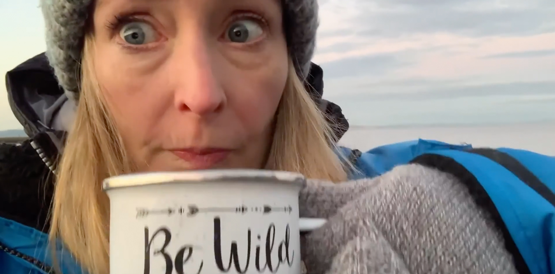 Close up of Vicky Allen drinking from a time cup to get warm after wild water swimming