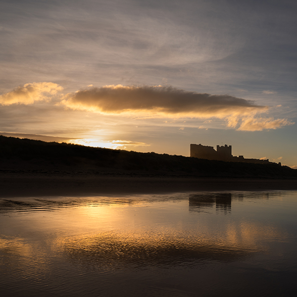Looking over the beach to Bamburgh Castle at sunset