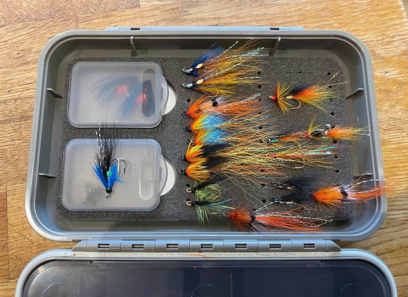 Box of fishing flies of various sizes and colour
