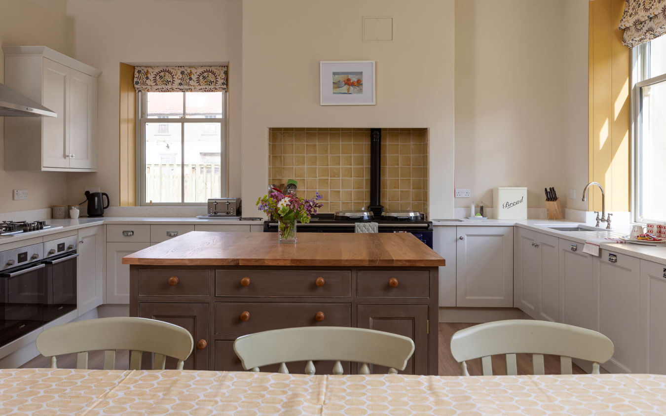 Northumberland Holiday Cottages Wild Plum Crookham Eastfield Farmhouse Kitchen view showing windows an aga