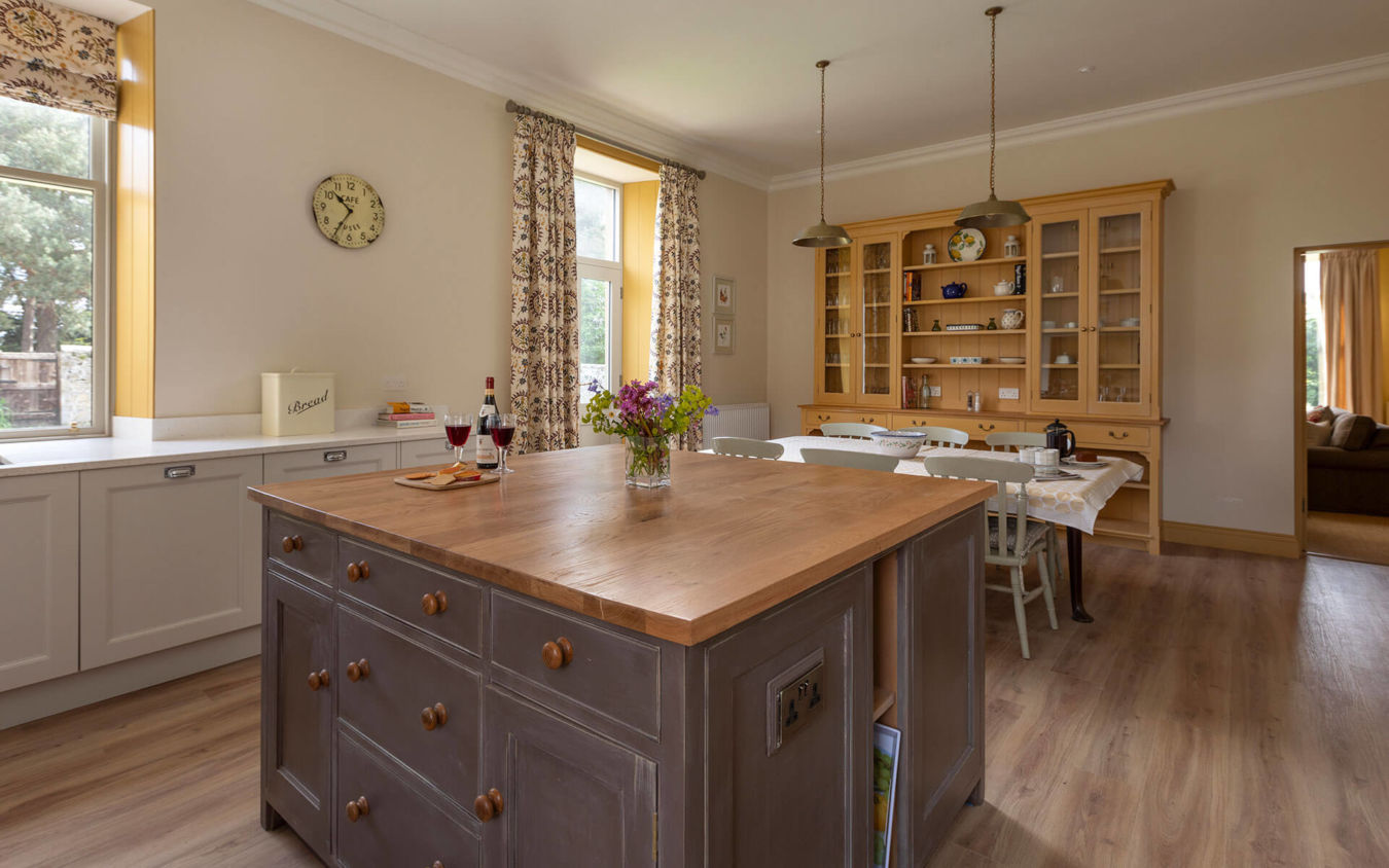 Northumberland Holiday Cottages Wild Plum Crookham Eastfield Farmhouse Kitchen view showing table and view to snug