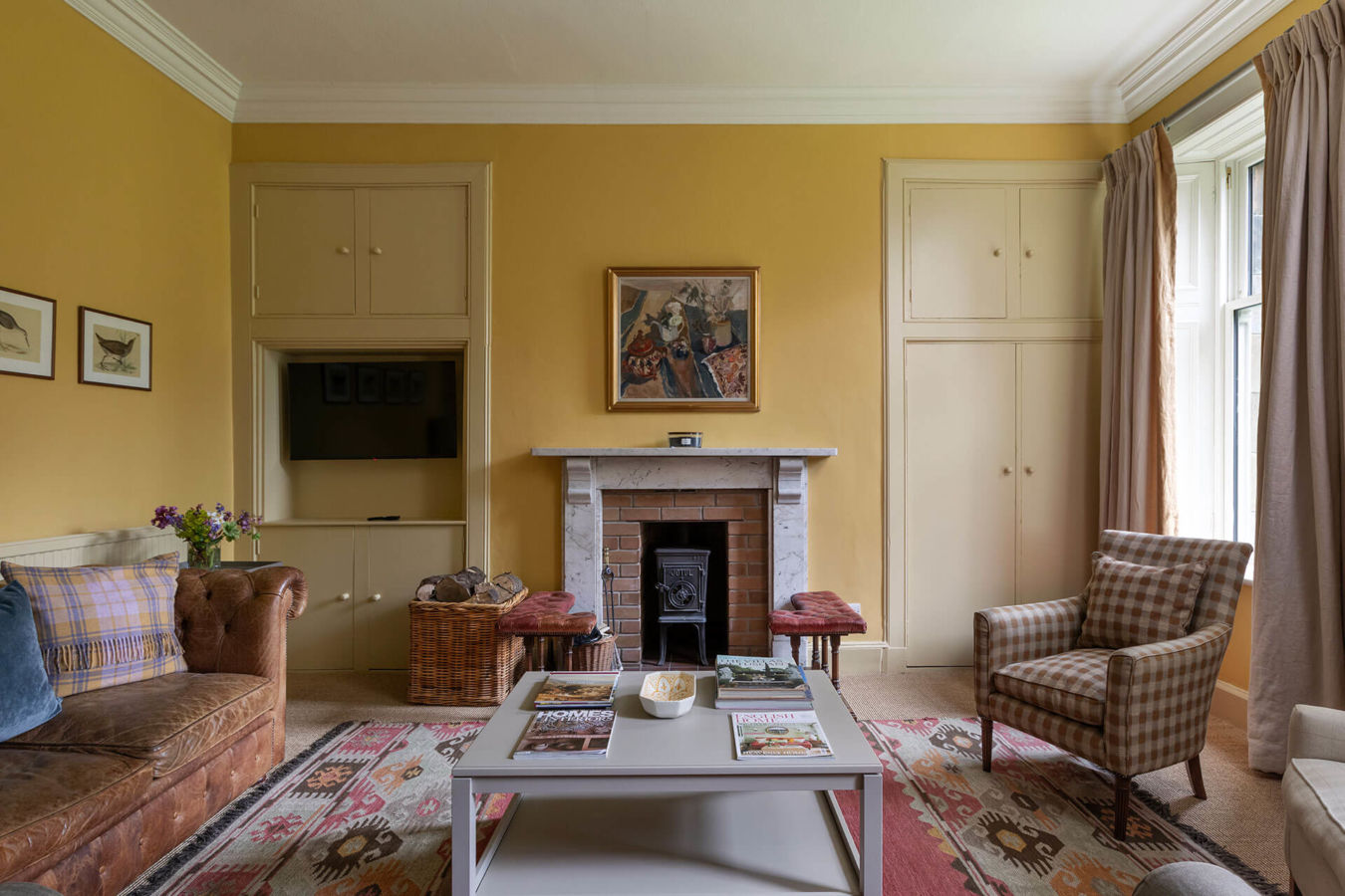 Northumberland Holiday home Wild Plum Crookham Eastfield Farmhouse view of the cosy Library facing the fire and drinls cabinet