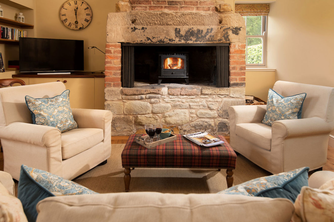 Living room with feature fire place in the Smith, one of the wild plum cottages